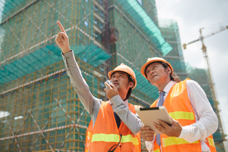 Asian architect and engineer working at construction site